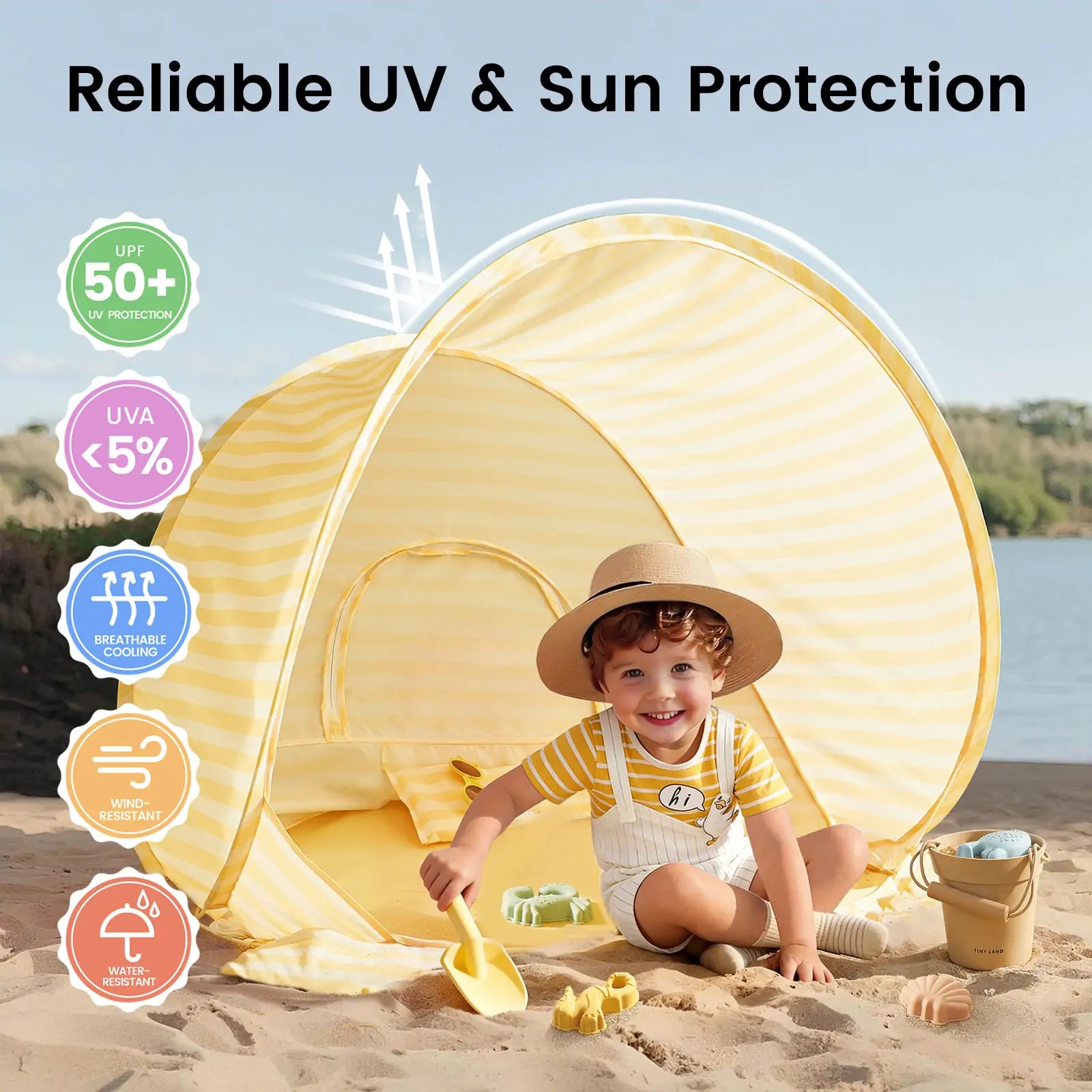 A young child enjoys the shore with the Tiny Land® One-Stop Beach Toy & Tent Set – Pastel Yellow Stripes. The UV 50+ protective tent from Tiny Land offers UVA <5%, is breathable, wind and water resistant—perfect for sun-safe play.|Pastel Yellow Stripes
